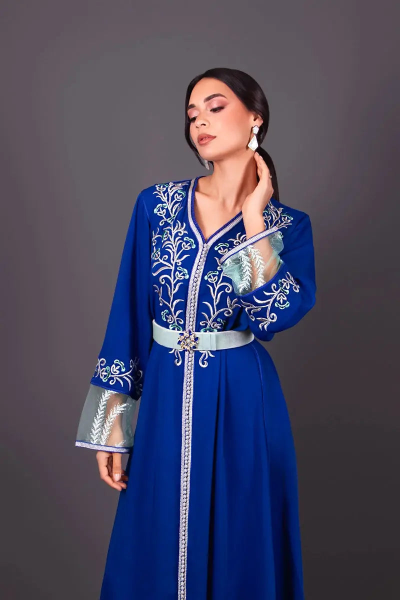 Royal blue crepe caftan worn by a woman, full-length view