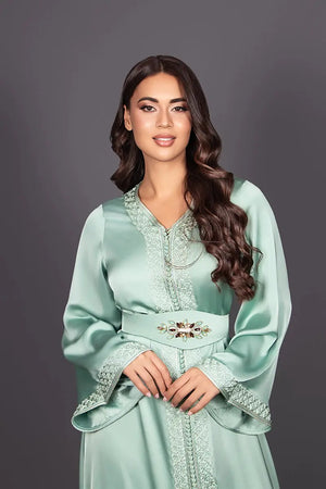Traditional green silk caftan with Moroccan embroidery and flared sleeves